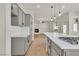 Open-concept kitchen with island gas range and a view of the living area at 11621 La Mirago Pl, Las Vegas, NV 89138