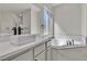 Bright bathroom featuring a soaking tub, a sleek faucet, and a modern sink basin at 11621 La Mirago Pl, Las Vegas, NV 89138
