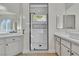 Bright bathroom features a large glass shower, double sinks, and sleek white countertops at 11621 La Mirago Pl, Las Vegas, NV 89138