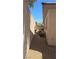 Side yard with gravel and view of fountains in backyard at 11621 La Mirago Pl, Las Vegas, NV 89138