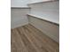 Spacious walk-in closet with wooden shelving and wood-look flooring at 11621 La Mirago Pl, Las Vegas, NV 89138