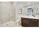 Modern bathroom features a glass enclosed shower and dark wood cabinets at 11895 Skyline Arch Ct, Las Vegas, NV 89138