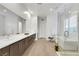 Modern bathroom featuring double vanity, walk-in shower, soaking tub, and contemporary fixtures at 11895 Skyline Arch Ct, Las Vegas, NV 89138