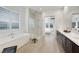 This modern bathroom features a soaking tub, glass-enclosed shower, and dual sink vanity with stylish finishes at 11895 Skyline Arch Ct, Las Vegas, NV 89138