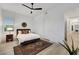 Bright bedroom features wood-look floors, ceiling fan, and decor rug at 11895 Skyline Arch Ct, Las Vegas, NV 89138