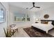 Serene bedroom with a large window, soft lighting, and a cozy rug that adds warmth to the space at 11895 Skyline Arch Ct, Las Vegas, NV 89138