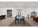 Modern dining room with view to the living room, featuring light wood floors at 11895 Skyline Arch Ct, Las Vegas, NV 89138