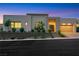 Contemporary home showcasing clean lines, desert landscaping, and a two-car garage at 11895 Skyline Arch Ct, Las Vegas, NV 89138