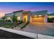 Modern home's exterior features xeriscaping, concrete driveway, and two-car garage at 11895 Skyline Arch Ct, Las Vegas, NV 89138