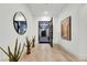 Bright, minimalist foyer with hardwood floors and a view into a sunlit courtyard at 11895 Skyline Arch Ct, Las Vegas, NV 89138