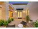 Inviting front entrance featuring an awning, outdoor seating, and lush landscaping for a welcoming feel at 11895 Skyline Arch Ct, Las Vegas, NV 89138