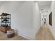Hallway features wood floors, modern decor, and access to rooms in the house at 11895 Skyline Arch Ct, Las Vegas, NV 89138