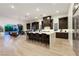 Modern kitchen with an extended island, stainless steel appliances, custom cabinets, and seating area at 11895 Skyline Arch Ct, Las Vegas, NV 89138