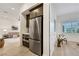 This kitchenette features stainless steel appliances, dark cabinetry, and convenient access to the living areas at 11895 Skyline Arch Ct, Las Vegas, NV 89138