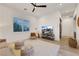 Bright living room with large window, comfortable seating, and recessed lighting at 11895 Skyline Arch Ct, Las Vegas, NV 89138