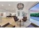 Bright living room with view of the pool and backyard, featuring modern lighting and an open-concept design at 11895 Skyline Arch Ct, Las Vegas, NV 89138