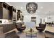 Spacious living room featuring hardwood floors, stylish light fixture, and an open floor plan with kitchen access at 11895 Skyline Arch Ct, Las Vegas, NV 89138