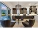 Open-concept living area with hardwood floors, dark cabinetry, and modern lighting at 11895 Skyline Arch Ct, Las Vegas, NV 89138