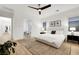 Well-lit main bedroom with white walls, wood floors, and minimalist decor for a serene and inviting atmosphere at 11895 Skyline Arch Ct, Las Vegas, NV 89138
