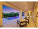 Covered patio featuring an in-ground pool, seating, and landscaped backyard at 11895 Skyline Arch Ct, Las Vegas, NV 89138