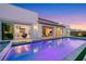 Stunning backyard pool with covered patio and seamless indoor-outdoor living at dusk at 11895 Skyline Arch Ct, Las Vegas, NV 89138