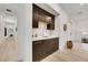 Convenient wet bar area with dark cabinets, countertop space, and a sink, perfect for entertaining at 11895 Skyline Arch Ct, Las Vegas, NV 89138