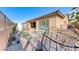 Serene backyard featuring stone pavers, decorative gravel, and a cozy hanging chair at 125 Mirage View Dr, Henderson, NV 89011
