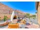 Charming backyard with a stucco fireplace, desert landscaping, and inviting lounge chairs at 125 Mirage View Dr, Henderson, NV 89011