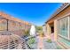 Backyard featuring a stucco fireplace, desert landscaping, mountain views, and lounge chairs at 125 Mirage View Dr, Henderson, NV 89011