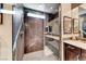Modern bathroom showcasing a spacious shower with gray hexagon tile and a built-in bench at 125 Mirage View Dr, Henderson, NV 89011