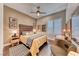 Stylish bedroom with a detailed headboard, ceiling fan, and a patterned accent rug at 125 Mirage View Dr, Henderson, NV 89011
