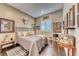 Comfortable bedroom featuring hardwood floors, a cozy bed, and eclectic decorations at 125 Mirage View Dr, Henderson, NV 89011