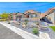 Charming desert landscaping enhances this attractive single-story home's curb appeal at 125 Mirage View Dr, Henderson, NV 89011