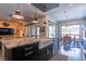 Modern kitchen showcasing granite counters, a farmhouse sink, stainless appliances, and an island with seating at 125 Mirage View Dr, Henderson, NV 89011