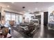 Bright living room with glass doors to outdoor patio, stylish decor, and open flow to modern kitchen at 125 Mirage View Dr, Henderson, NV 89011