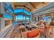 Bright living room with vaulted ceilings, fireplace, and floor-to-ceiling windows showcasing stunning mountain views at 125 Mirage View Dr, Henderson, NV 89011