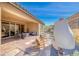 Patio with a fireplace, desert landscaping, outdoor dining, seating, and mountain views at 125 Mirage View Dr, Henderson, NV 89011