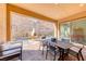 Inviting covered patio with stone pavers, an outdoor fireplace, and scenic desert mountain views at 125 Mirage View Dr, Henderson, NV 89011