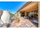 Backyard with a fireplace, desert landscaping, outdoor dining, mountain views, and lounge chairs at 125 Mirage View Dr, Henderson, NV 89011