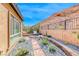Side yard with desert landscaping, brick pavers, mountain backdrop, and outdoor seating at 125 Mirage View Dr, Henderson, NV 89011