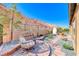 Side yard features desert landscaping, brick pavers, mountain views, and a hanging lounge chair at 125 Mirage View Dr, Henderson, NV 89011