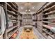 Spacious walk-in closet with custom shelves, drawers, and a seating area with decorative rug at 125 Mirage View Dr, Henderson, NV 89011