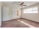Bedroom features a ceiling fan, plush carpeting, natural light, and closet space at 1309 Dorothy Ave # 4, Las Vegas, NV 89119