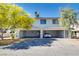 Home exterior featuring attached garages, desert landscaping, and mature trees on a sunny day at 1309 Dorothy Ave # 4, Las Vegas, NV 89119