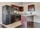 Modern kitchen featuring stainless appliances, dark wood cabinets, and a granite breakfast bar at 1309 Dorothy Ave # 4, Las Vegas, NV 89119