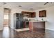 Open kitchen with stainless steel appliances, dark wood cabinets, and breakfast bar area at 1309 Dorothy Ave # 4, Las Vegas, NV 89119