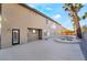 Home's backyard with pool, mature trees, concrete patio, and outdoor lighting at 1316 Eagle Meadow Ct, Las Vegas, NV 89123