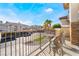 A balcony view shows outdoor seating, a neighborhood view and palm trees at 1316 Eagle Meadow Ct, Las Vegas, NV 89123