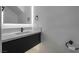 Contemporary bathroom featuring black hardware, white marble counters and an illuminated mirror at 1316 Eagle Meadow Ct, Las Vegas, NV 89123