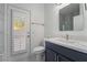 A renovated bathroom features white countertops, a vanity and access to the exterior at 1316 Eagle Meadow Ct, Las Vegas, NV 89123